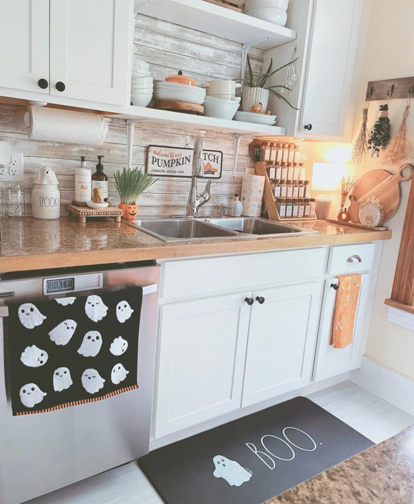 Sink-side setup featuring a ghost tea towel and a “BOO” floor mat for cheerful Halloween vibes.