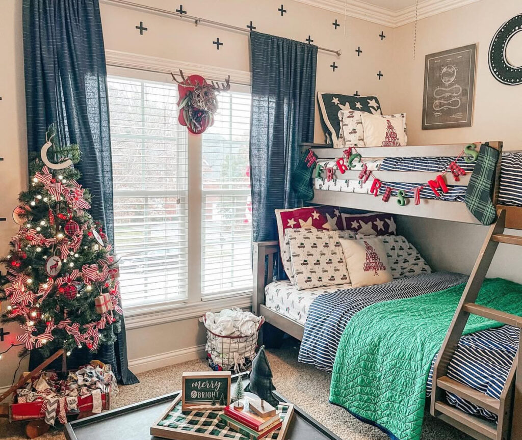 Bunk beds with striped bedding, garland, and a mini tree—kids Christmas bedroom ideas with playful red-and-green accents. Presents and ribbons complete the cheerful holiday nook.