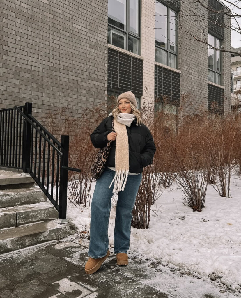 Oversized puffer, soft scarf, straight blue jeans, and platform boots during a cold-weather commute.