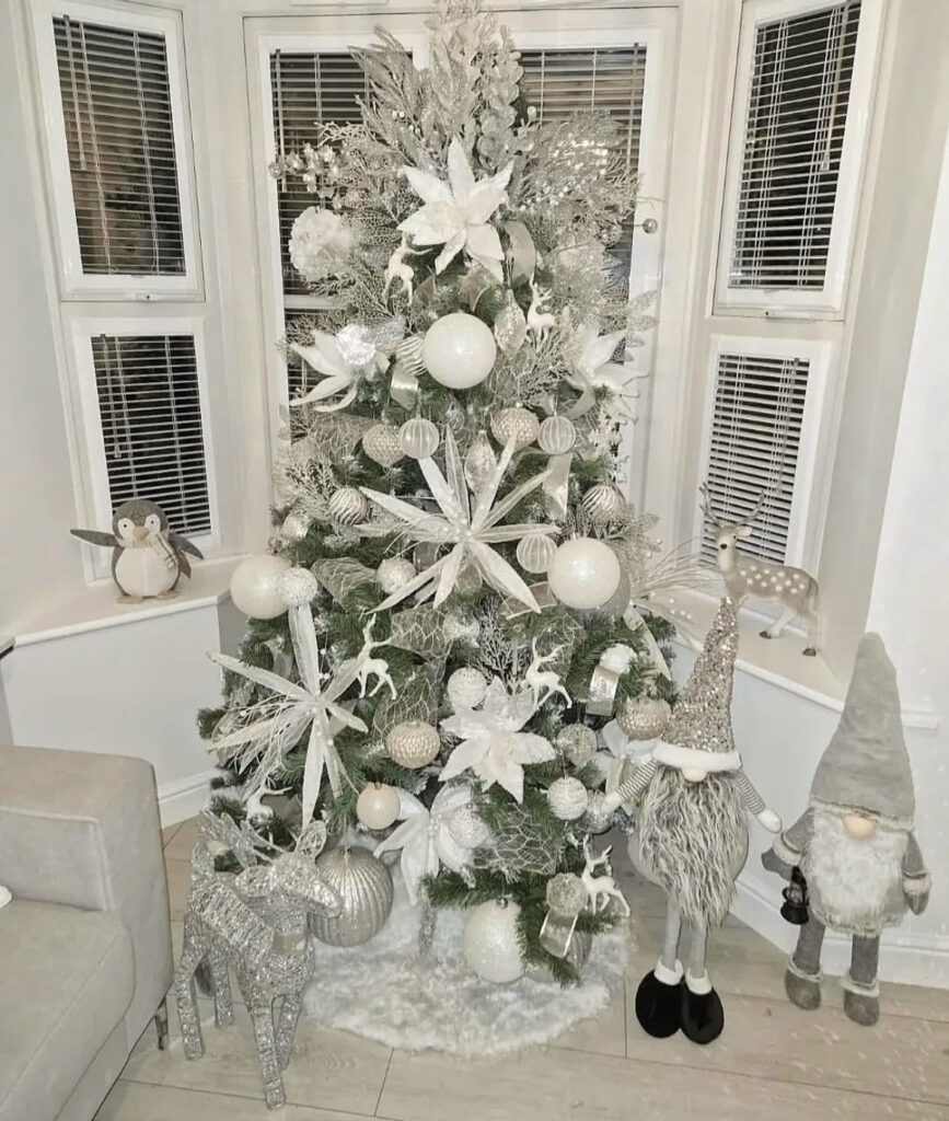Layered mesh and giant stars with gnomes—storybook white christmas tree ideas.