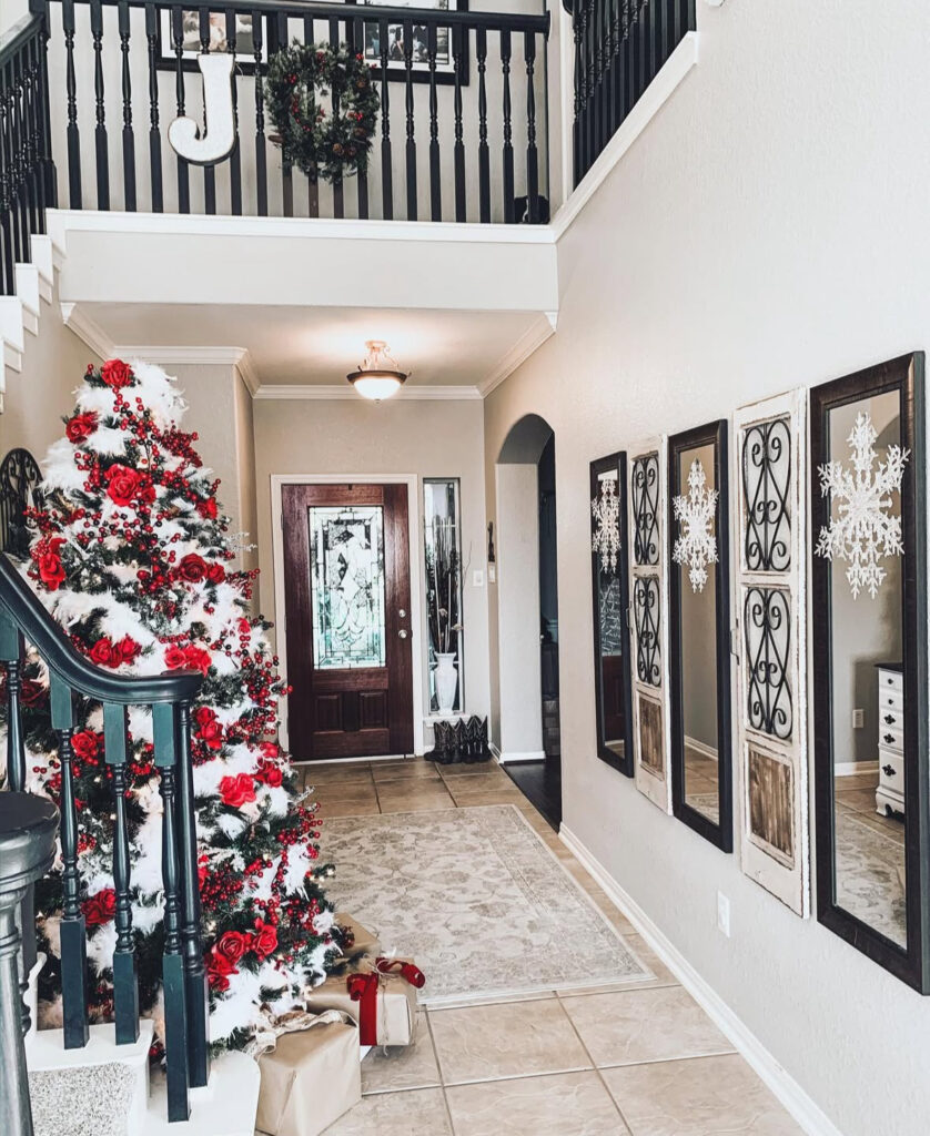 Black and white Christmas entryway with a pop of red decor