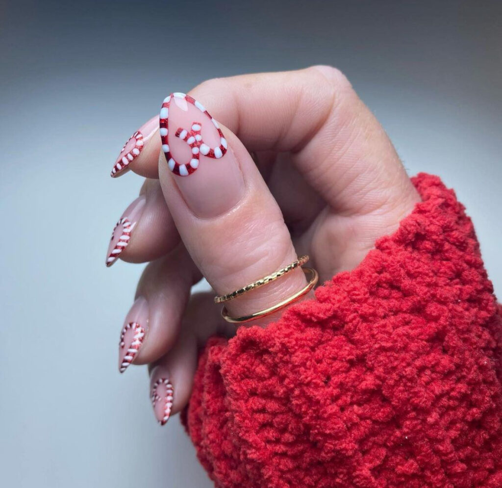 Candy cane nail designs with pink heart outlines