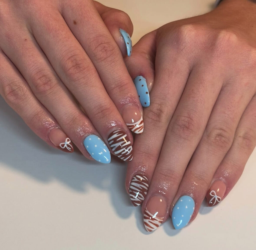 Cocoa swirl nails with icy dots and tiny bows