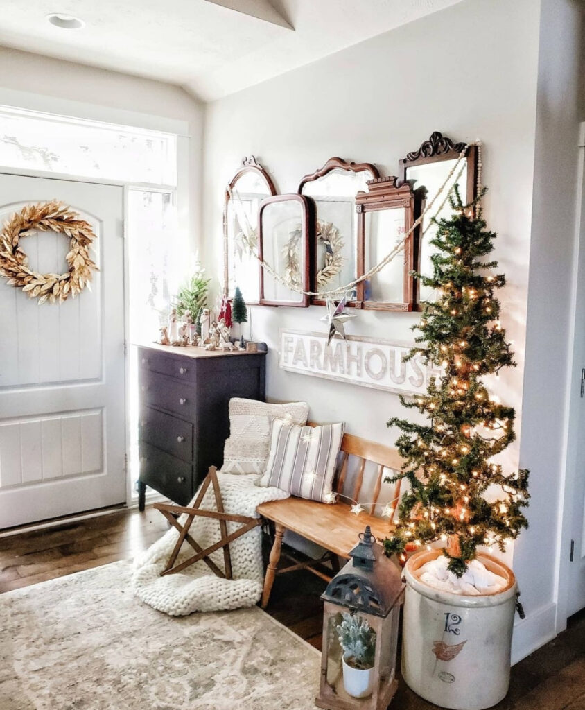 Collected farmhouse entry decorated with twinkle lights and festive greenery