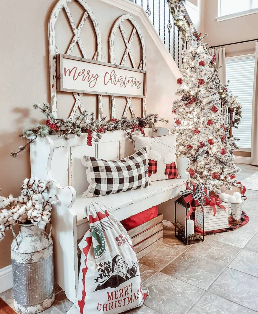 Cozy bench nook with flocked Christmas tree and warm accents