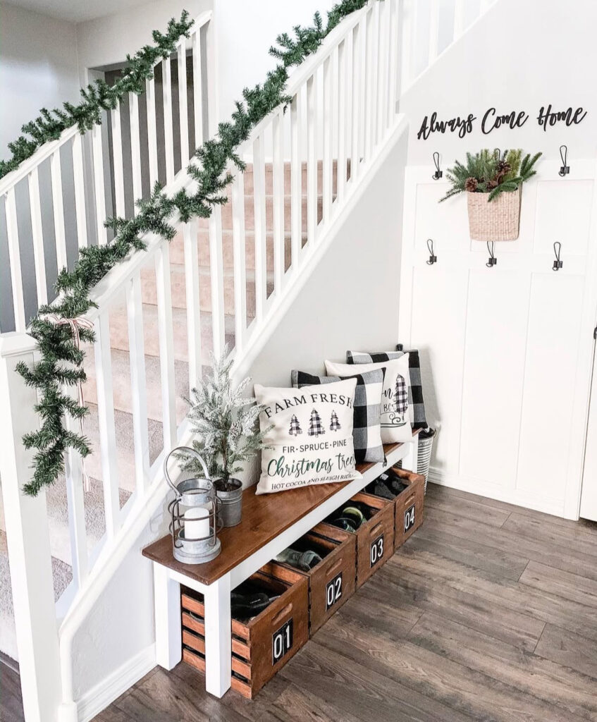 Farmhouse style entry bench with holiday pillows and simple greenery