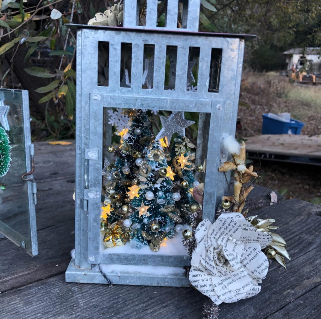 Galvanized metal lantern with woodland scene and pine details