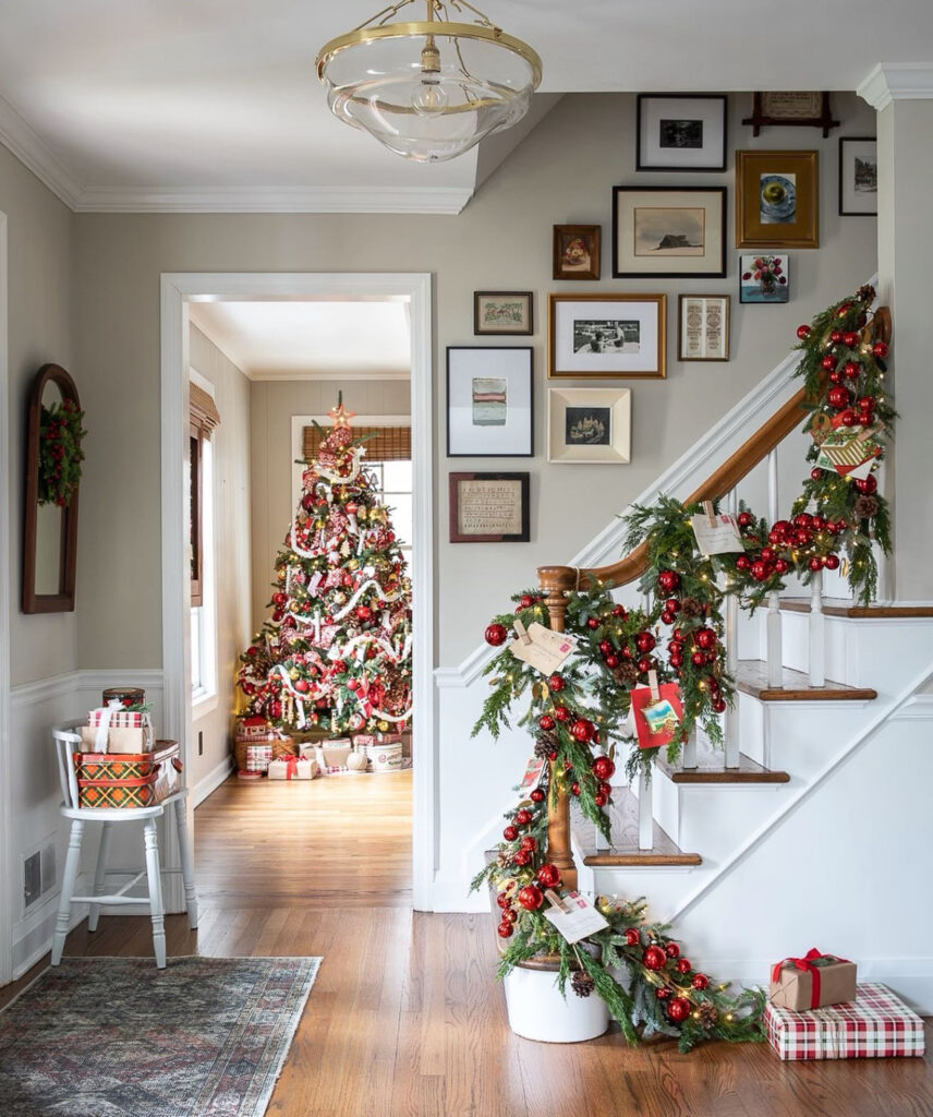 Staircase gallery wall decorated with draped Christmas garland