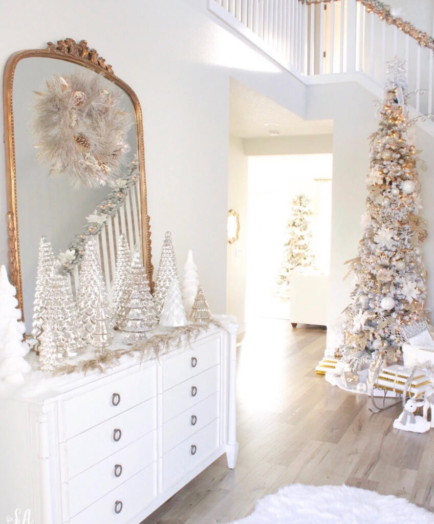 Gilded winter wonderland foyer with gold accents and festive decor