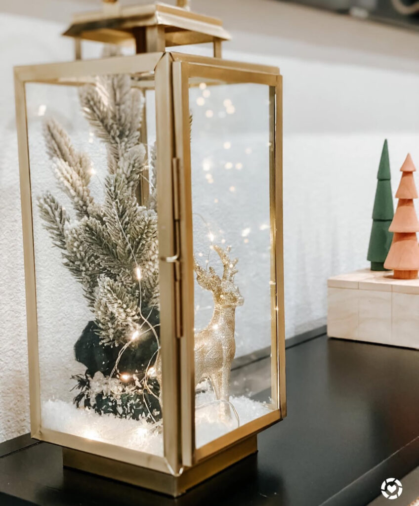 Lantern showcasing a golden stag figurine