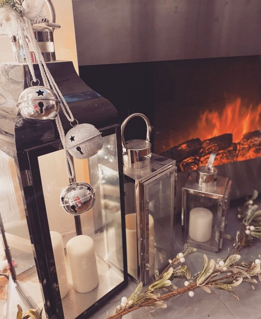 Black lantern with bells and mixed metal Christmas accents