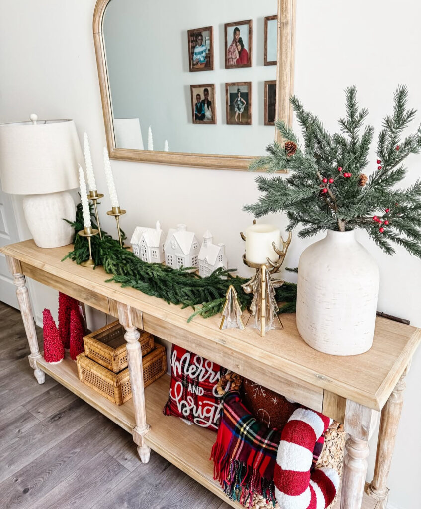 Light wood console decorated with a glowing mini village display