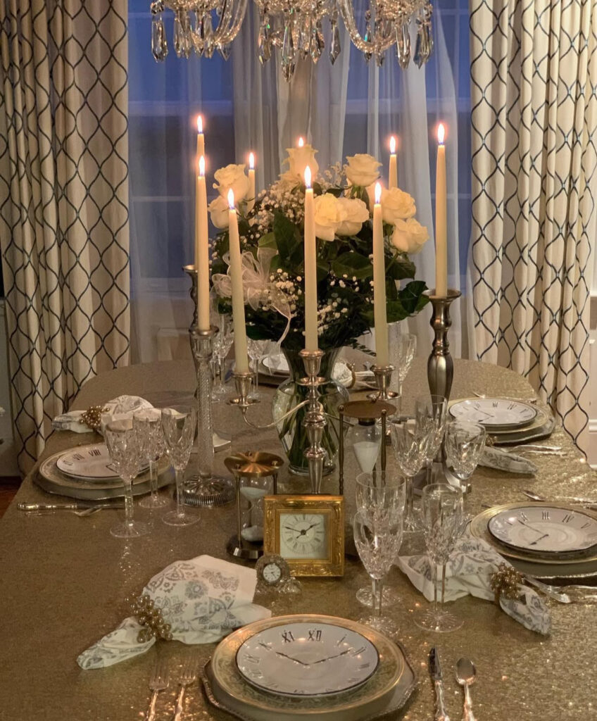 Sequin gold cloth with clock plates, hourglasses, roses, and tall candles.