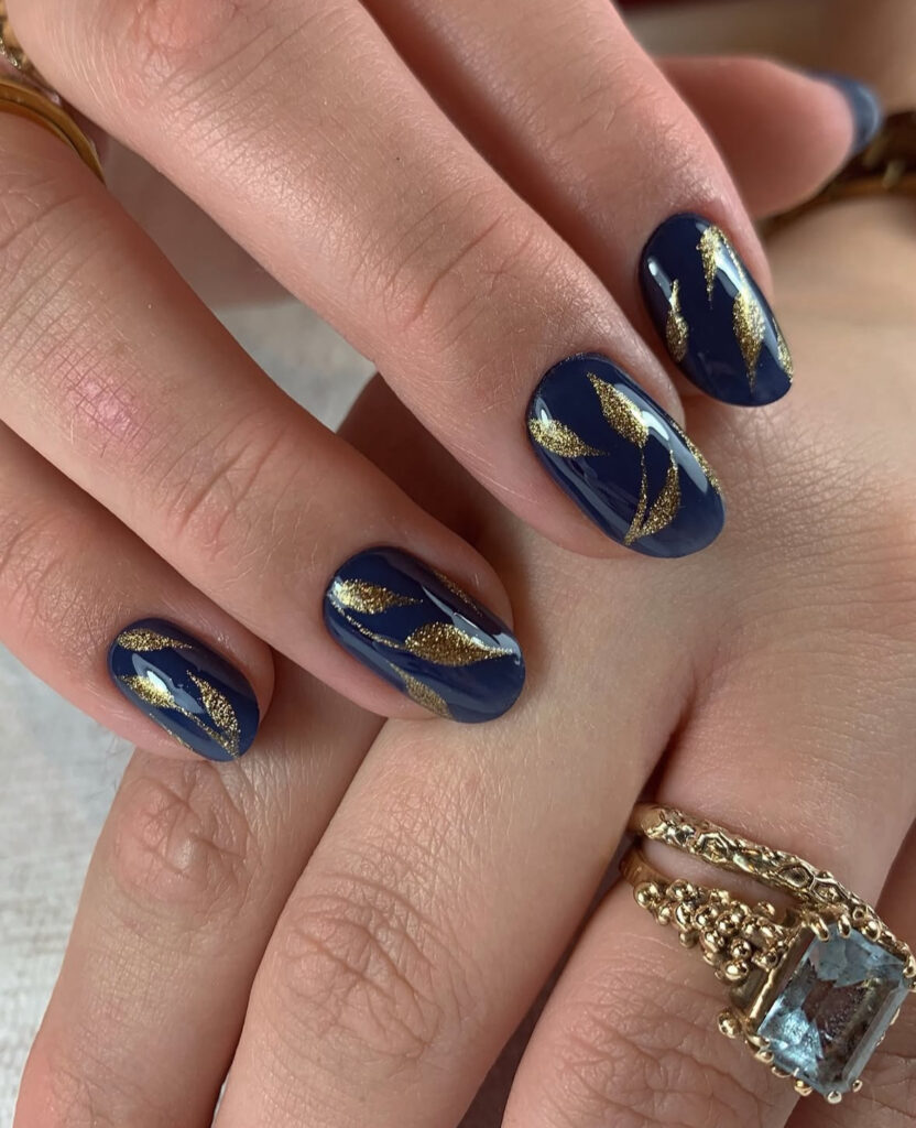 Deep blue nails with gold leaf details