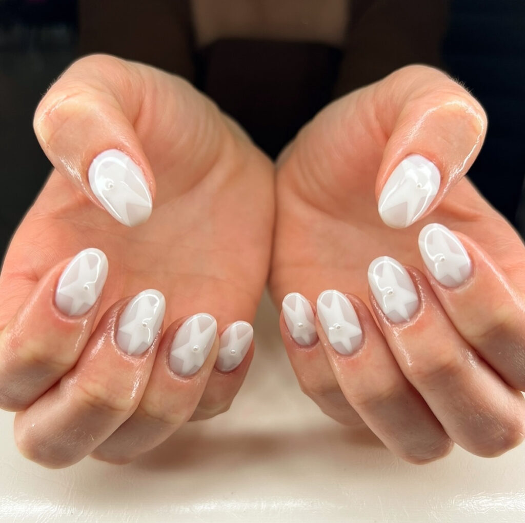 Milky glossy nails with starburst accents