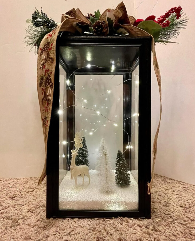 Mini snowy Christmas diorama inside a clear lantern