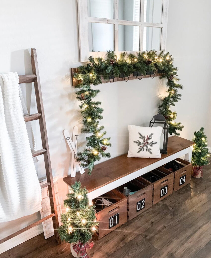 Mudroom bench decorated with green garland and festive accessories