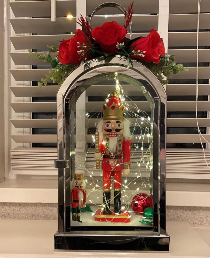 Nutcracker displayed inside a glass lantern stage