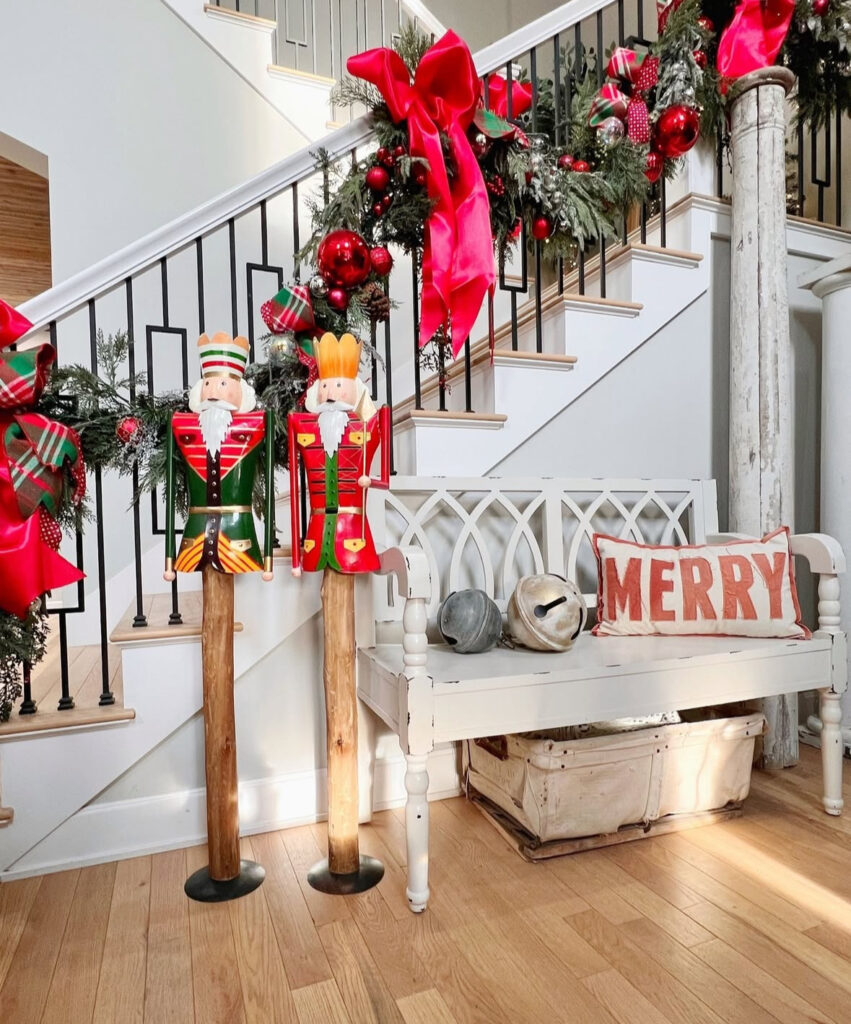 Nutcracker themed staircase with red bows and festive decor