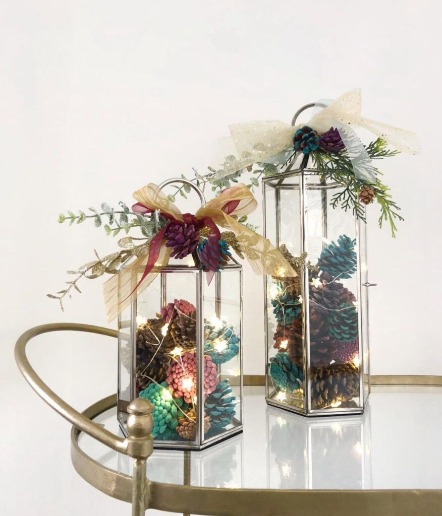 Lantern filled with painted pinecones and sparkle accents