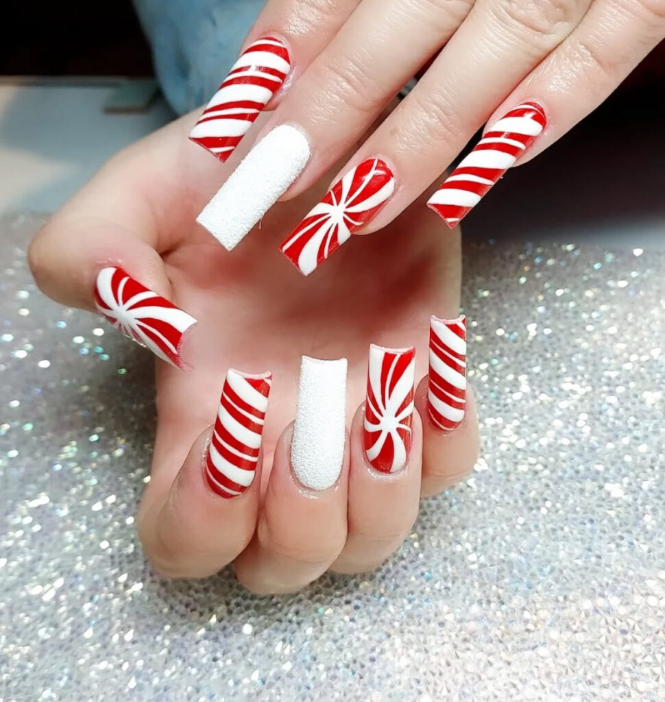 Red and white peppermint pinwheel party nails