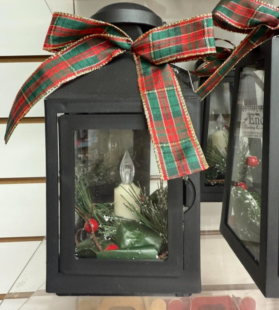 Lantern decorated with plaid ribbon in a cozy shop setting