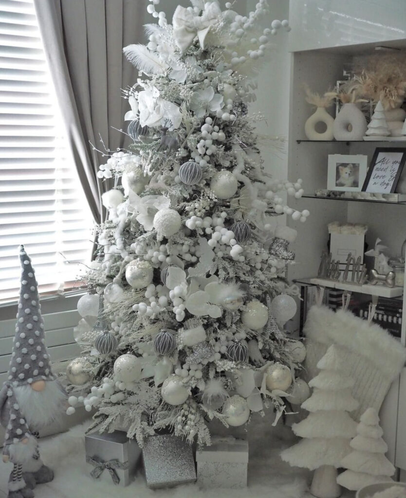 Flocked branches with berries and gnomes—whimsical white christmas tree decorations.