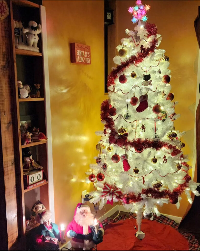 Red garland spiral and bells—classic white christmas tree decorations with vintage cheer.