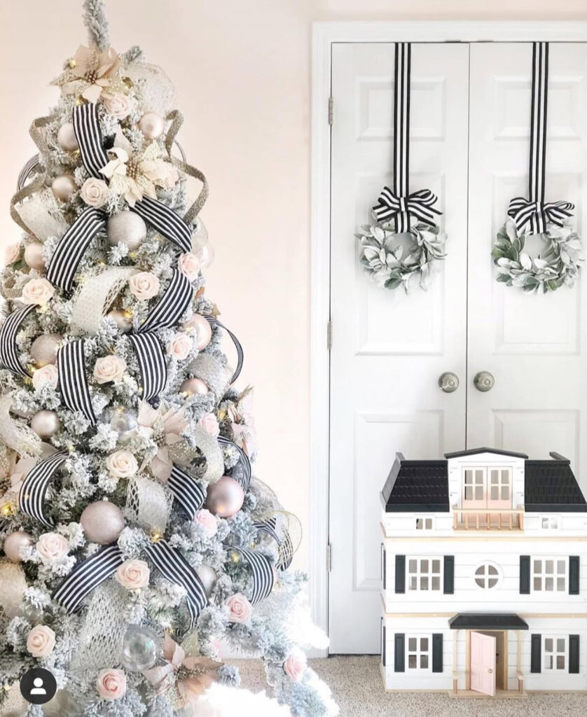 Ribboned showpiece with blush roses—grand, almost white house christmas tree energy.