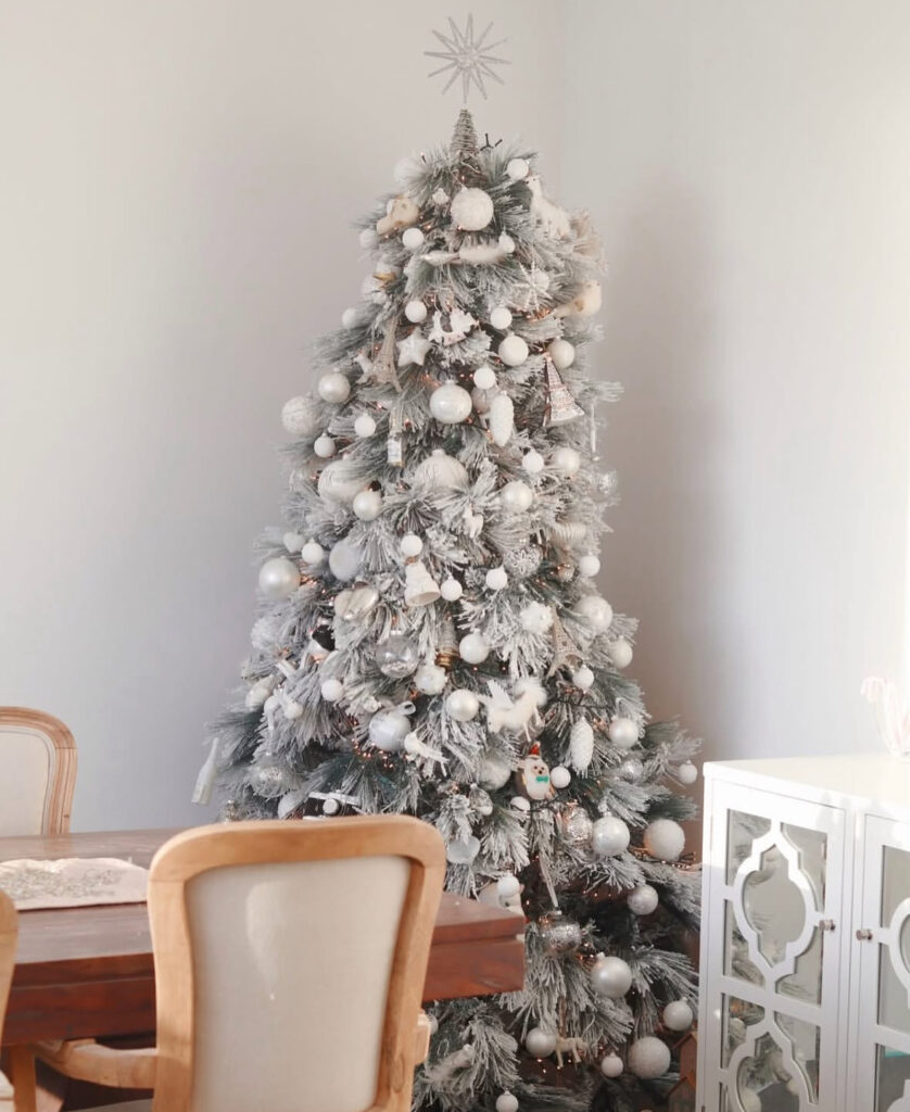 Scandi dining corner showing how to decorate a white christmas tree with all-white baubles.