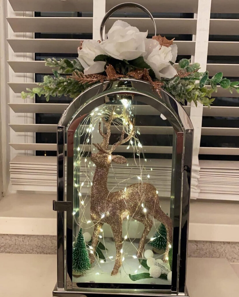 White lantern with silver stag and white roses