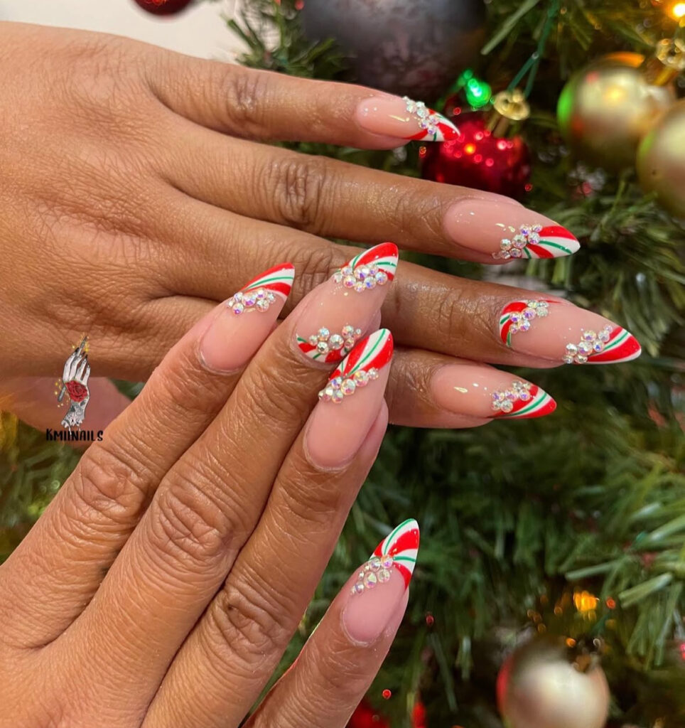 Candy cane striped nails with swoosh pattern and crystals