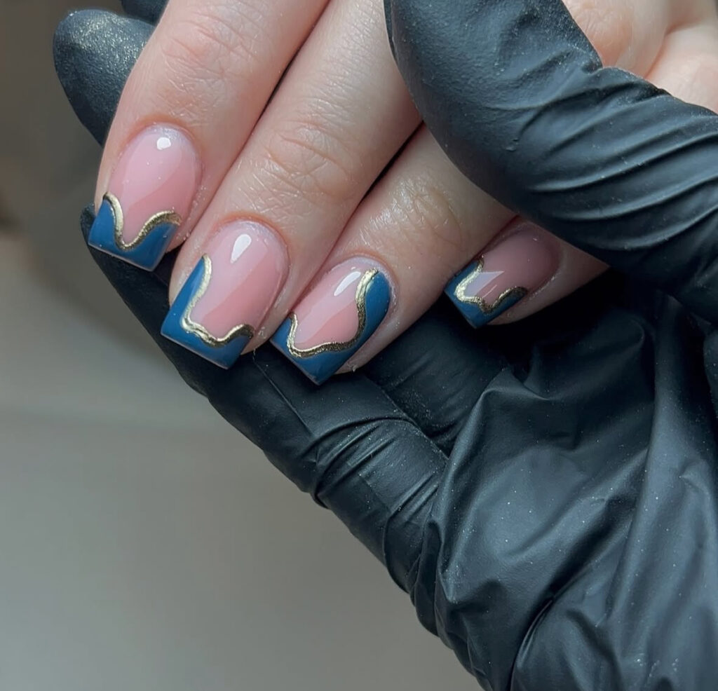 Teal wave French manicure with gold edging