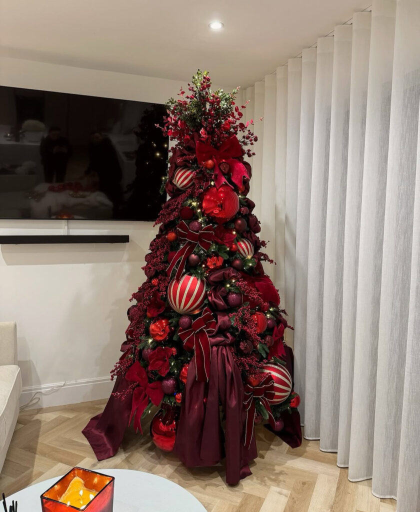 Velvet ribbon waterfall on a burgundy Christmas tree with candy stripe accents