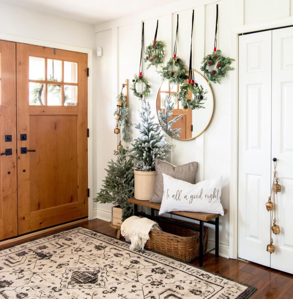 Cozy entry bench with wreaths and layered Christmas decor