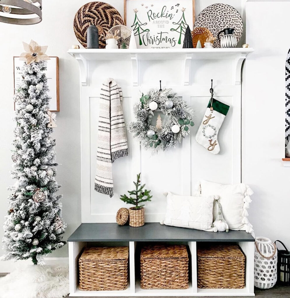 entry nook with flocked tree and baskets in boho Christmas styling