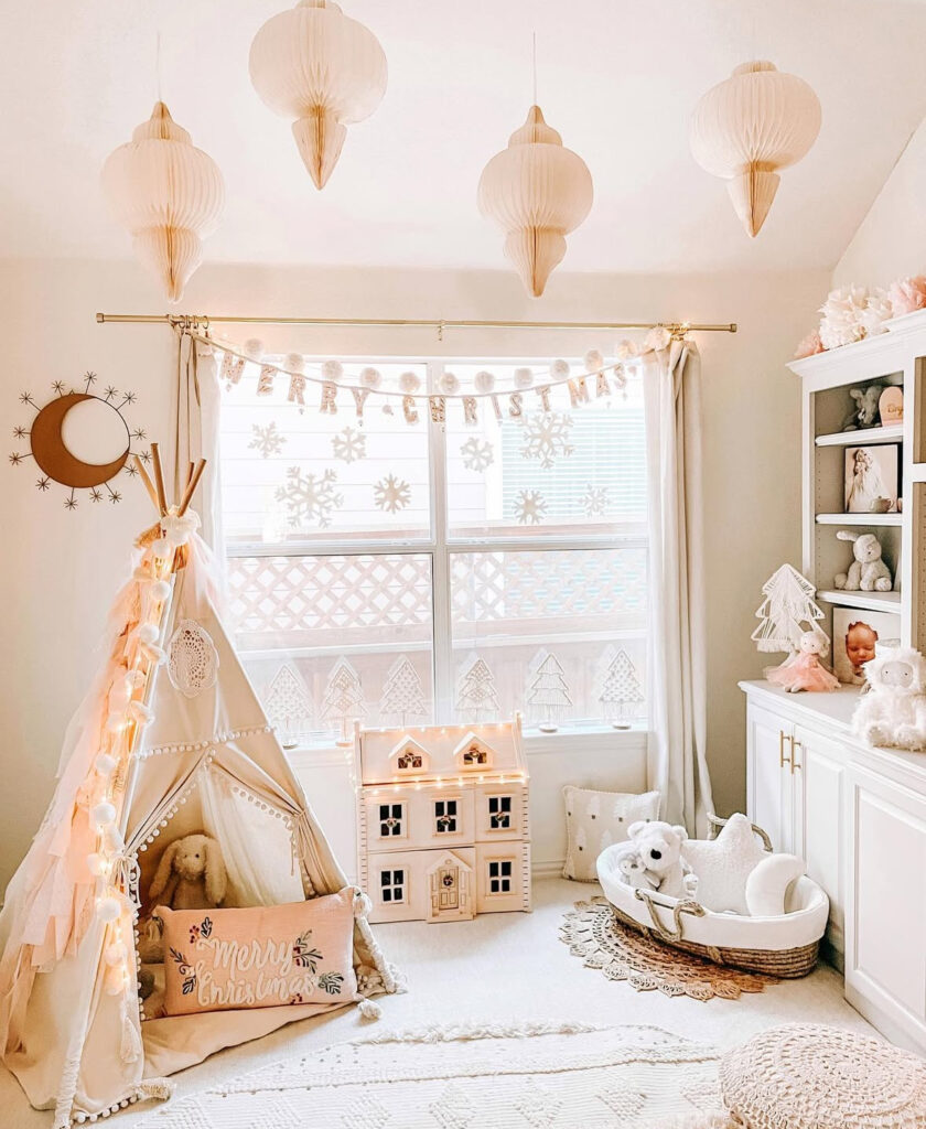 playroom with teepee and dollhouse decorated for boho Christmas