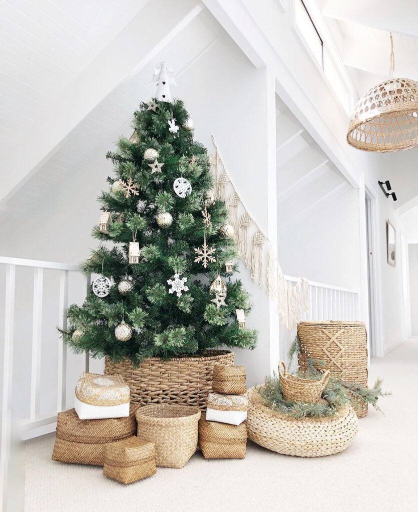 loft space with woven basket and presents under a boho Christmas tree