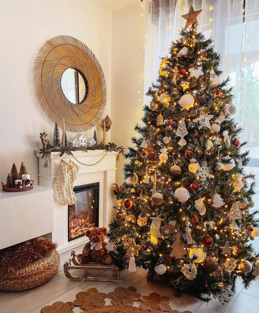rattan mirror and fireplace with Christmas tree in boho decor