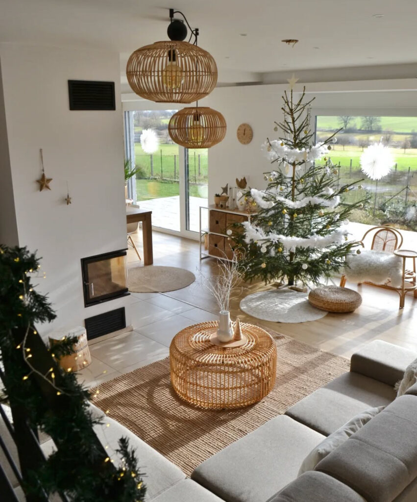sunlit living room with rattan tables and a real boho Christmas tree