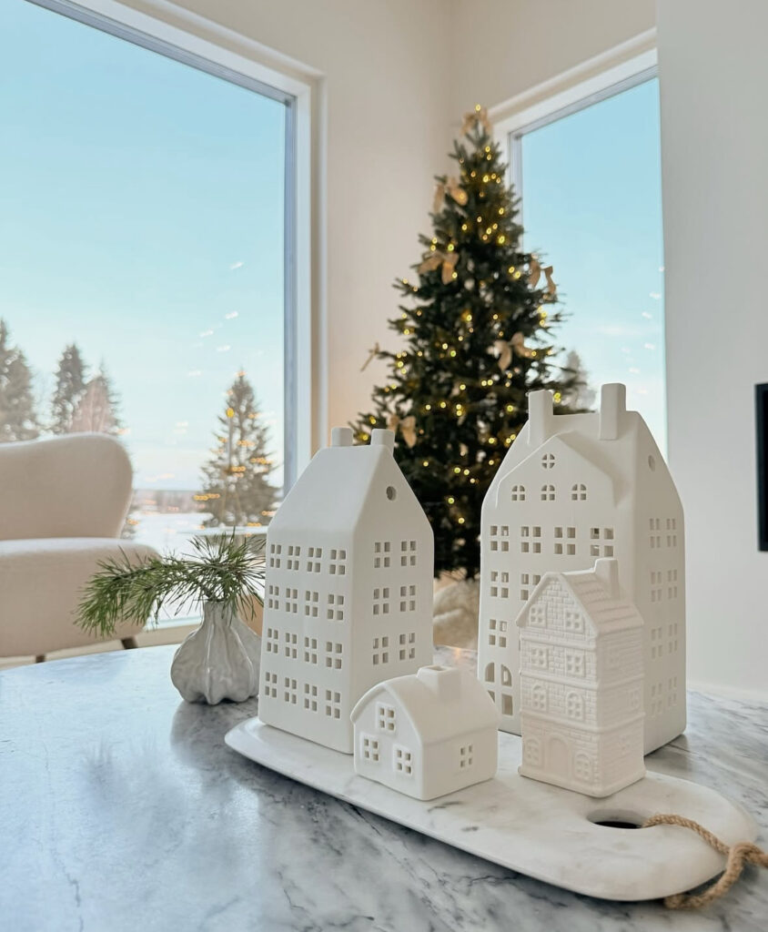 ceramic village displayed on marble with Scandinavian Christmas decor