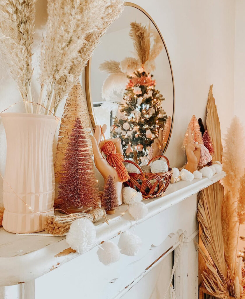 colorful mantel with pampas grass and bottle brush trees in boho Christmas decor