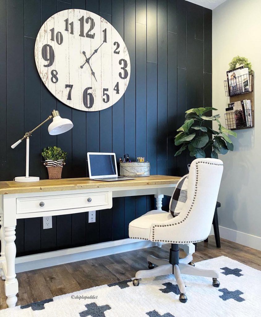 Farmhouse office decorated with navy shiplap and a large wall clock