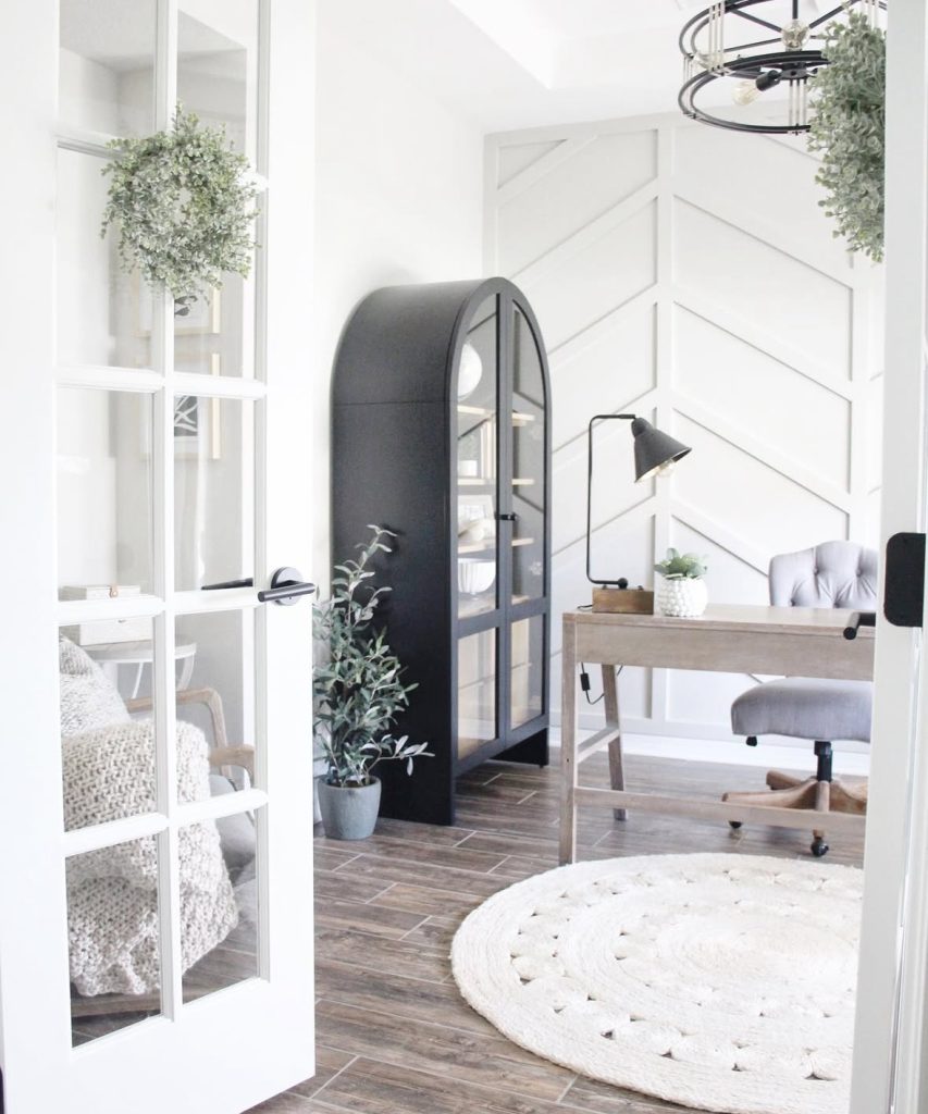 Farmhouse office with an arched cabinet and warm wood accents