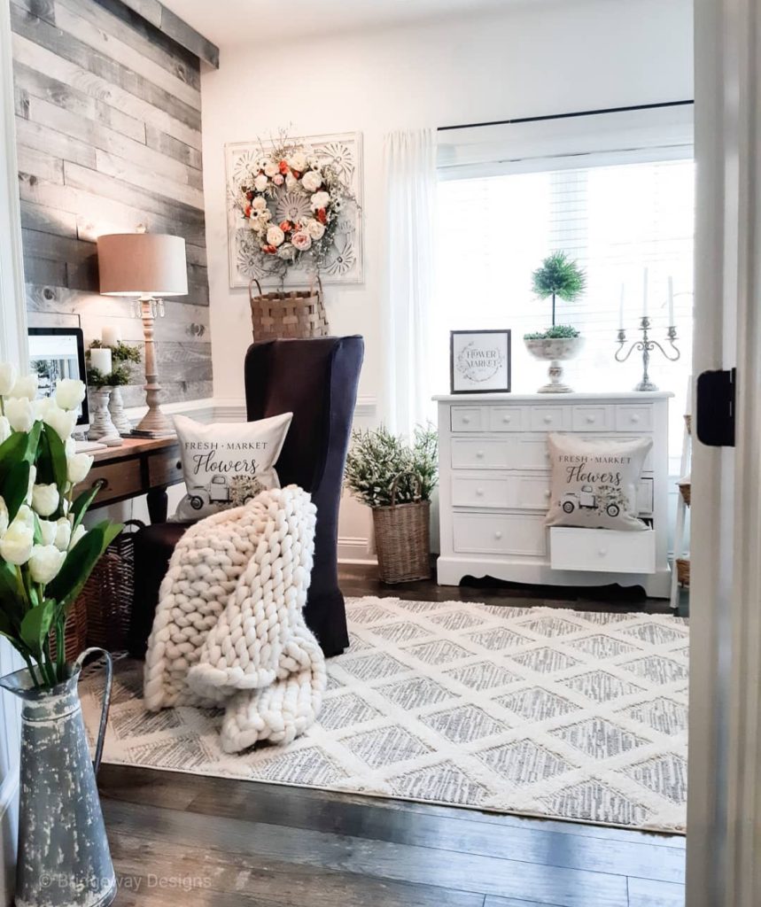 Farmhouse home office styled with floral cottage décor and a library wall