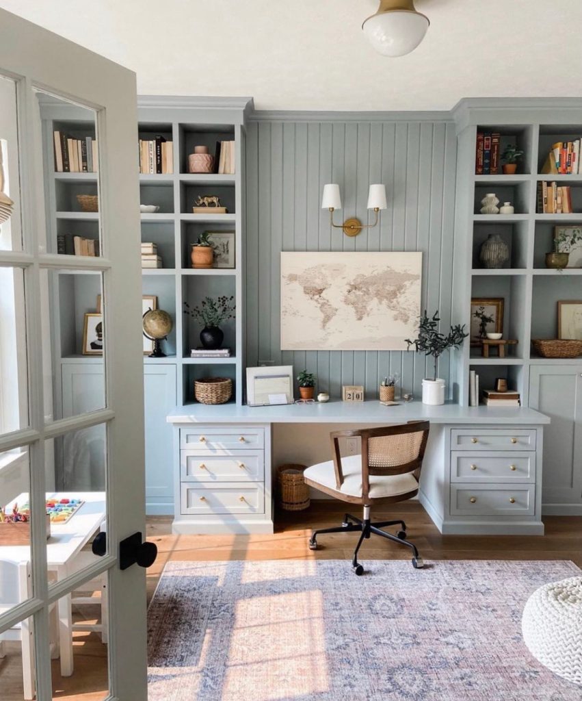 Farmhouse home office featuring blue built-in cabinets in a family workspace