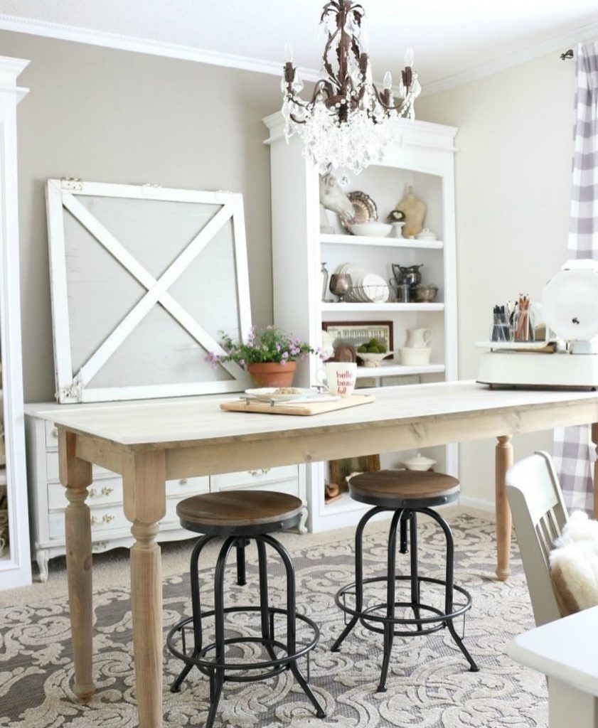 Farmhouse home office with a turquoise accent and a large studio table