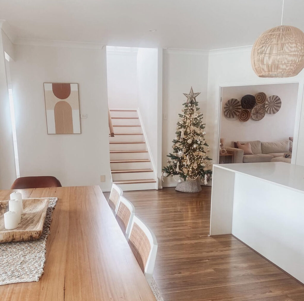 open-plan dining with rattan pendants and rustic boho Christmas decor