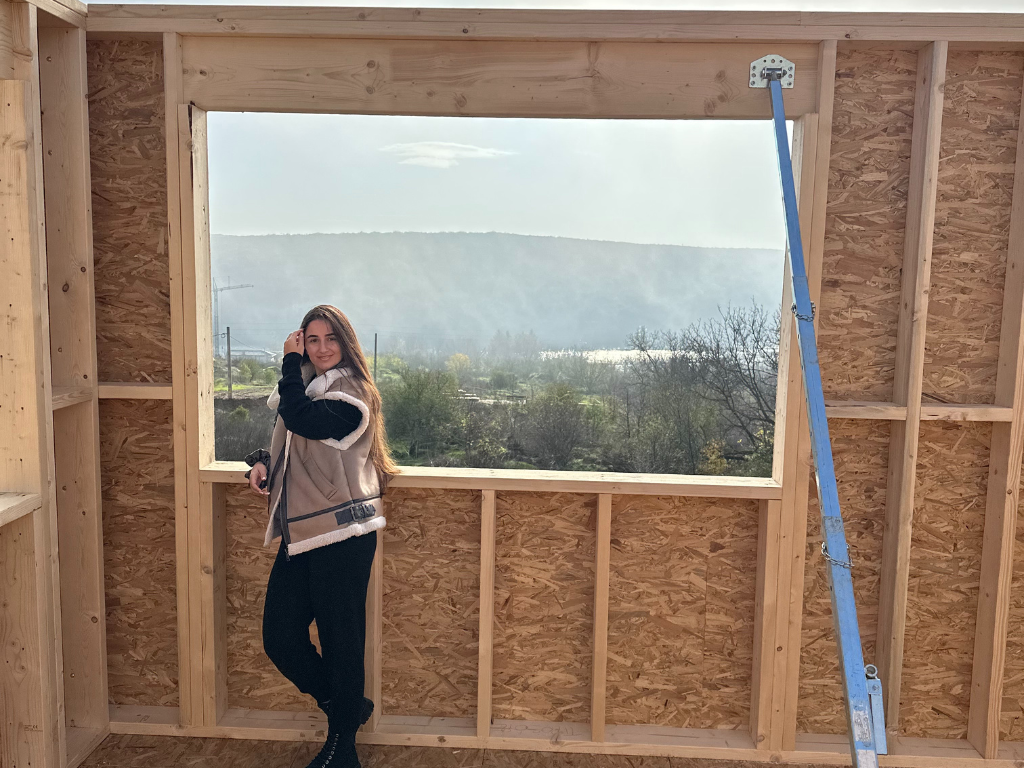 forest view from the second house  floor through the wooden frame of a future window