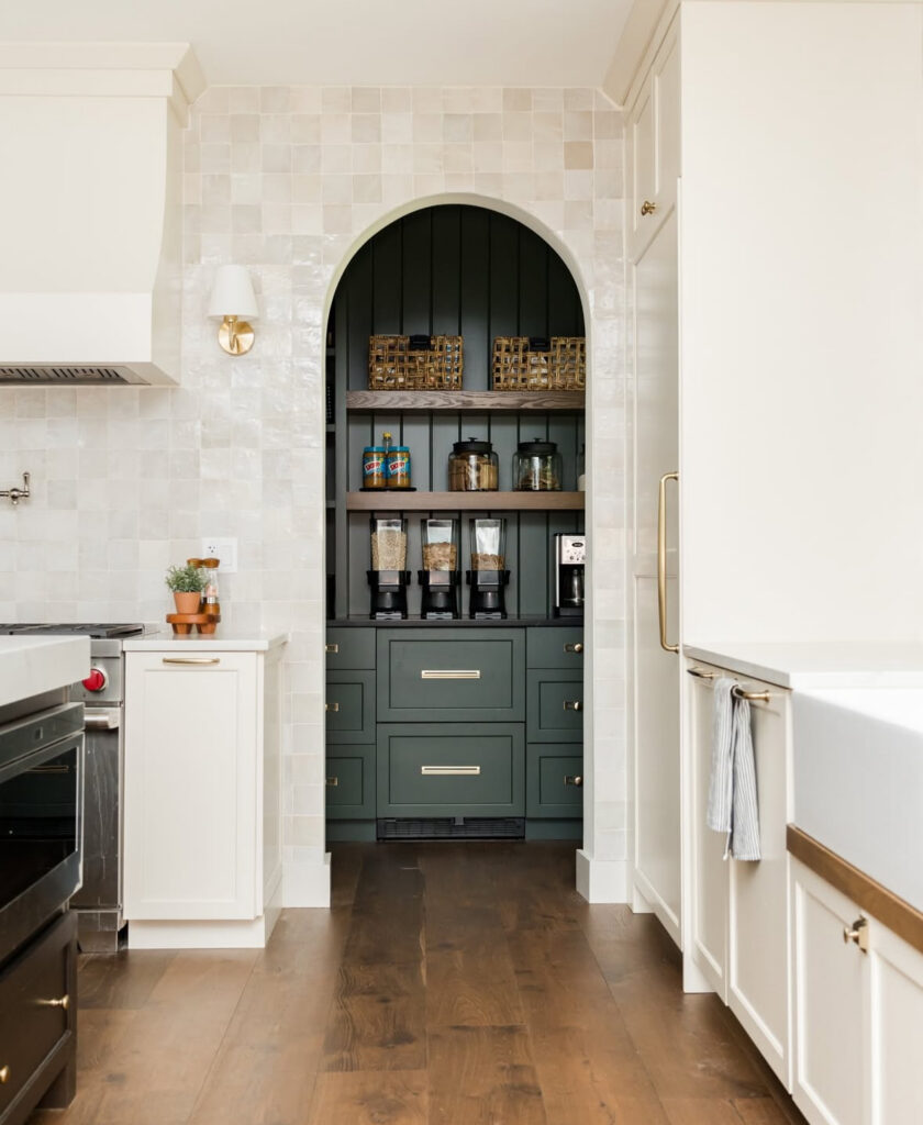 arched green niche with cereal dispensers baskets and jars offers smart walk in pantry organization ideas just off the main kitchen